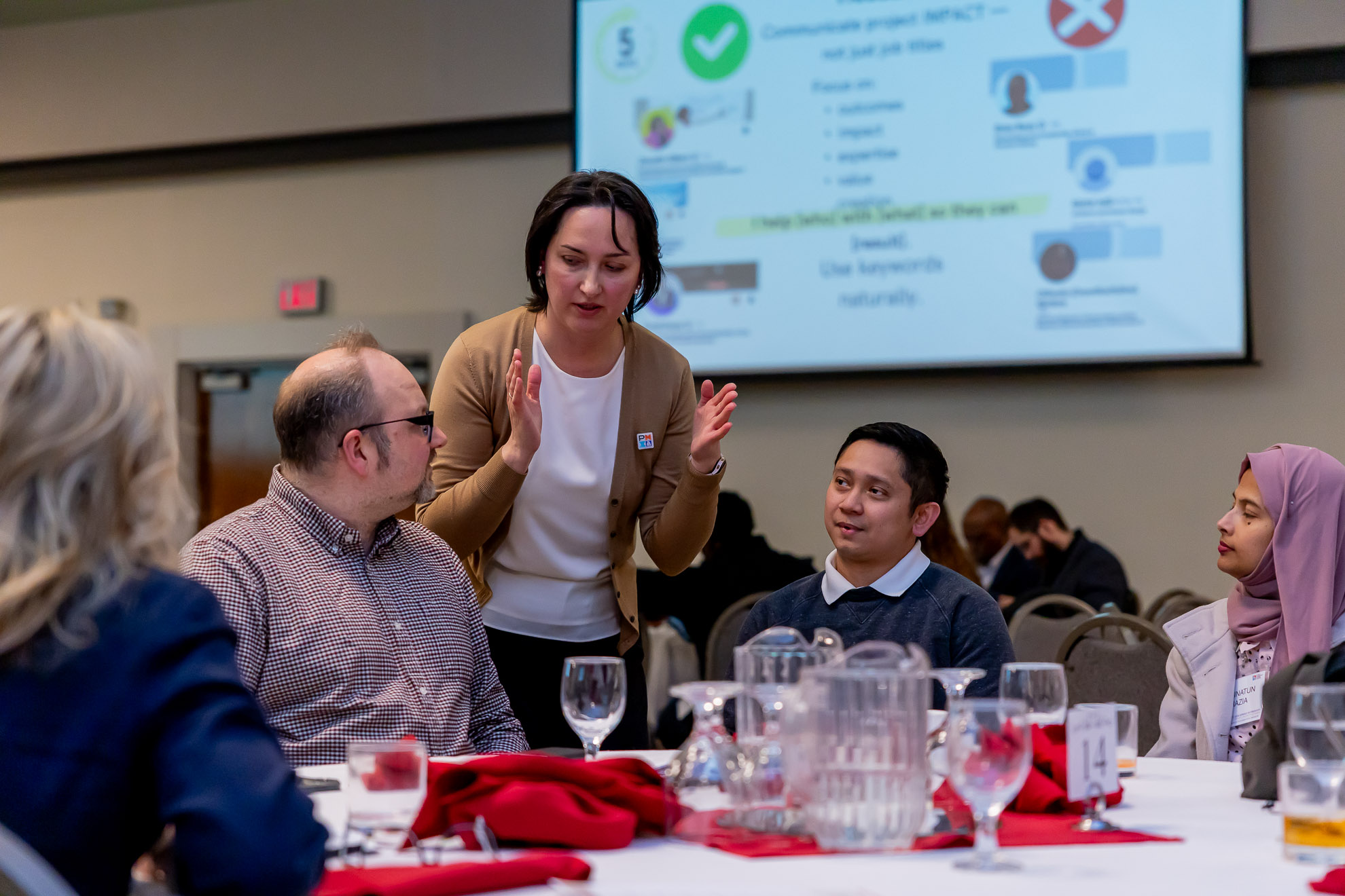 Margarita facilitating a discussion with participants around a workshop table